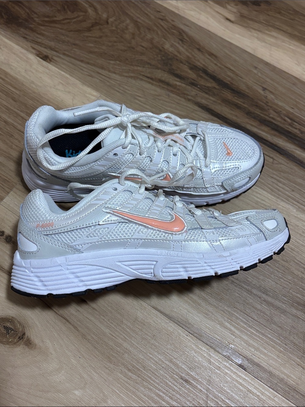Nike Women's White Athletic Sneakers with Peach Swoosh